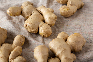 Raw Organic Ginger Root on cloth, low angle view. Close-up.