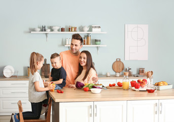 Young family cooking together in kitchen