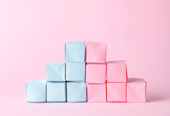 Paper cubes on color background. Concept of feminism