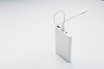 Power Bank for charging your smartphone on a white background. Universal external battery for gadgets free space and minimalistic composition.