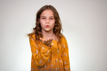 A kiss from a teen girl in white background, hand