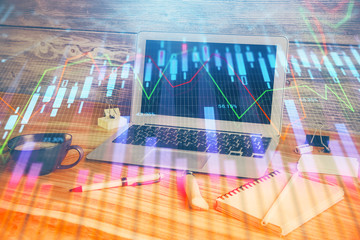 Double exposure of chart and financial info and work space with computer background. Concept of international online trading.