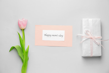 Beautiful flower and gift for Mother's Day on white background