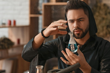 Male alchemist making elixir in laboratory