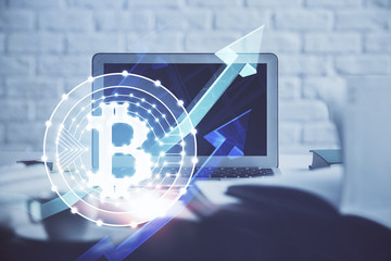 Multi exposure of blockchain and crypto economy theme hologram and table with computer background....