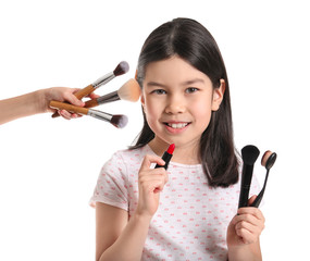Cute little makeup artist on white background