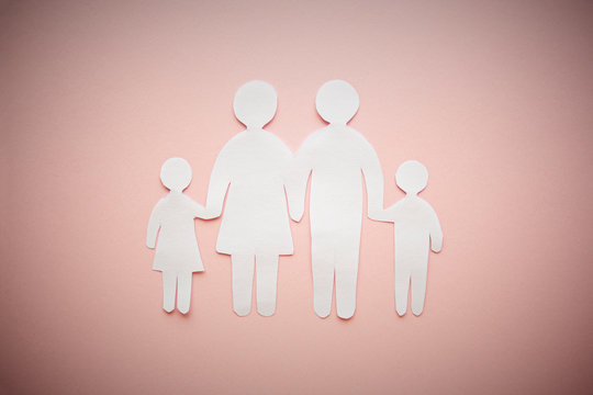 paper family cut out on bright pink background, family home, foster care, family mental health, homeschool education concept.