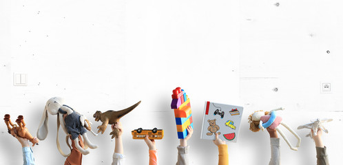 Children hands holding toys, concept of the childhood