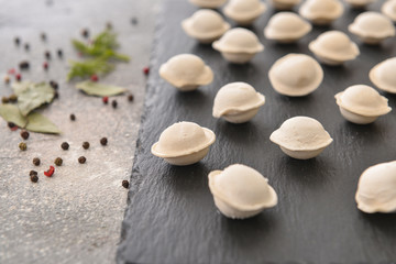 Raw fresh dumplings on slate plate, closeup