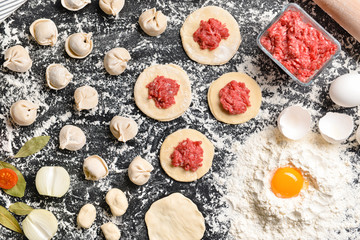 Making of tasty dumplings on dark background