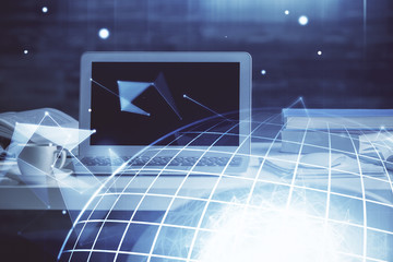 Multi exposure of table with computer and world map hologram. International data network concept.