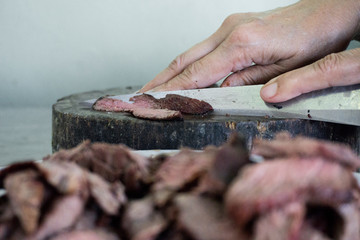 Woman cutting grilled meat with copy space