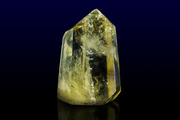 Piece of citrine on the surface of solid rock 