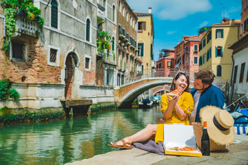 Fototapeta na wymiar couple having date at pier with beautiful view of venice canal