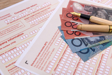 Australian tax form with pen and australian dollars on it. Taxation company