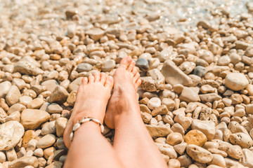 bracelet on legs woman at sea beach