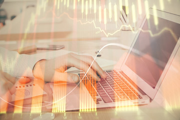 Double exposure of stock market graph with man working on laptop on background. Concept of financial analysis.