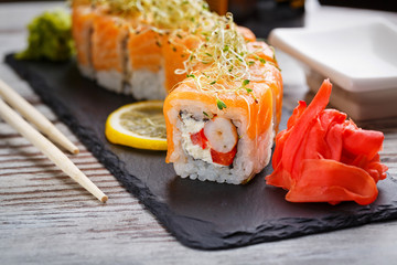 Philadelphia roll sushi with salmon and microgreen. Japanese food.