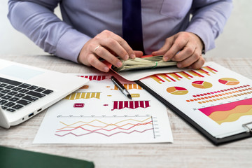 Businessman working in office. A man counts profits from renting or selling goods. Business...