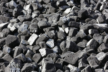 A scattering of gray slag on a sunny day.