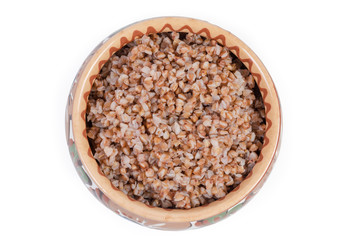 Naklejka premium Top view of buckwheat porridge in the clay bowl