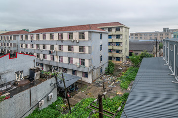Fototapeta premium Apartment building and garbage dump in small industrial city in China