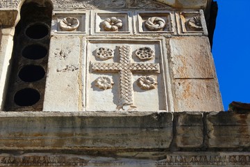 Carved stones decorate the exterior wall of an old Christian orthodox church in Athens, Greece