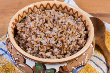 Buckwheat porridge in the clay bowl close-up