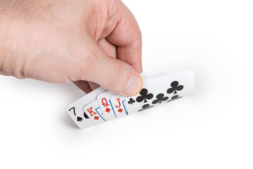 Male hand partly opens the combination of playing cards