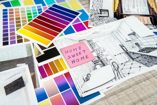drawing modern home with sample material on creative desk, at office
