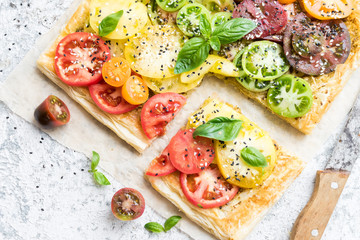 Vegetable puff pastry tart with colorful tomatoes