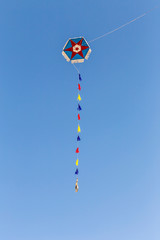 Bright kite with a pattern in the blue sky