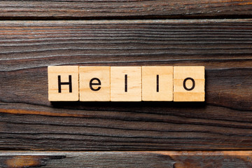 hello word written on wood block. hello text on table, concept