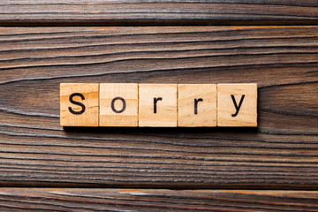 sorry word written on wood block. sorry text on table, concept