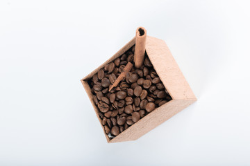 Coffee beans and cinnamons in a cardboard box