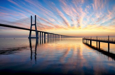 Fototapeta na wymiar Bridge Lisbon at sunrise, Portugal - Vasco da Gamma