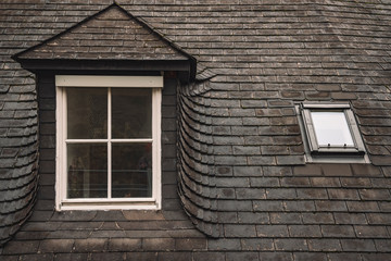 old house roof shingle cover and dirty window white wooden frame rustic European building background objects concept