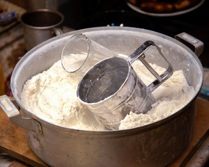 mechanical sieve for flour in a bowl with flour at home