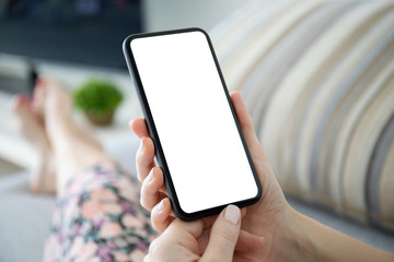 female hands holding phone with isolated screen in the room