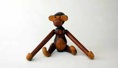 Oslo, Norway – February 24th ,2020: Vintage wood monkey figurine on white background, retro...