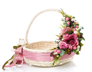 Fototapeta na wymiar Round white basket with easter floral decor of dark pink color.