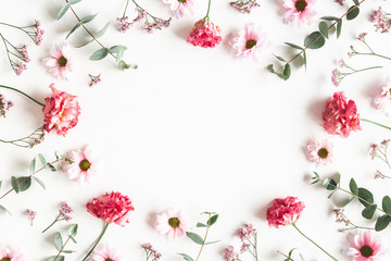 Flowers composition. Frame made of pink flowers and eucalyptus branches on white background....