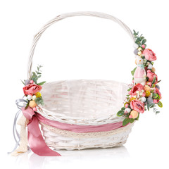 Fototapeta na wymiar Wicker basket with floral decor and ribbons on white background. Isolated