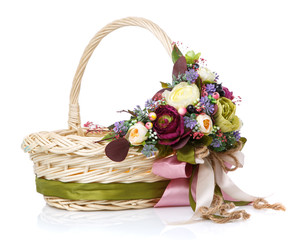 Fototapeta na wymiar Decorative wicker basket with original floral decor and long colored ribbons.