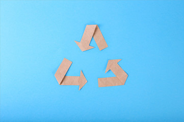 reused paper texture from recycle logo on blue background. Ecology protection concept