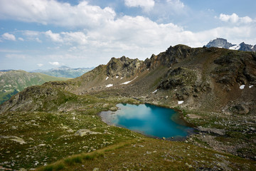 Fototapeta na wymiar Alpine turquoise lake of Sofia, surrounded by rocks. Karachay-Cherkessia, Arkhyz. Russia