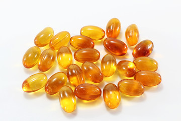 Top view of Cod liver oil capsules on white background.