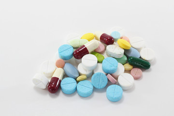 Various colorful medicine drugs, pills, capsules, tablets on white background.