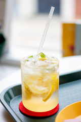 Honey lemon drink on the cafe table background