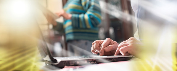 Businessman working on laptop; multiple exposure